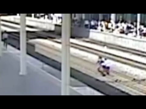 footage man jumps on rail tracks