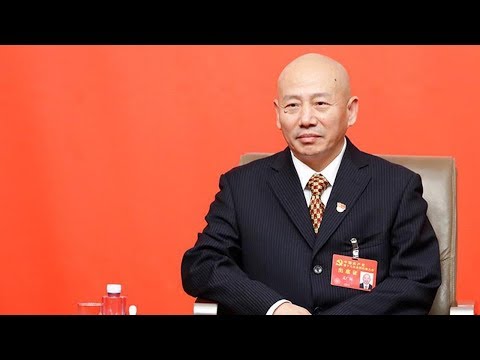 peking opera master sings during a group interview