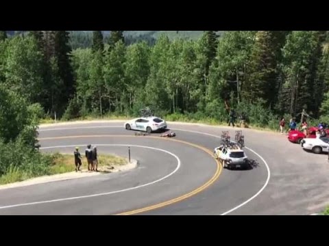 cyclist racing downhill crashes into moving car