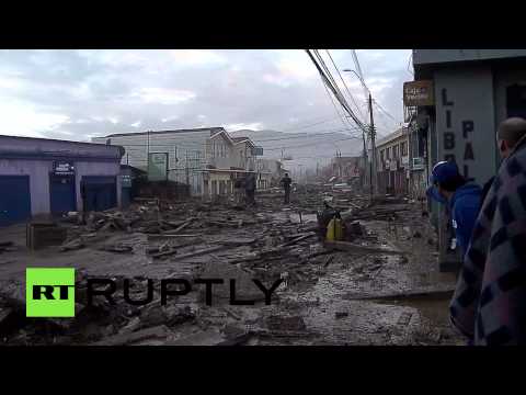 people pets struggle in mud and wreckage